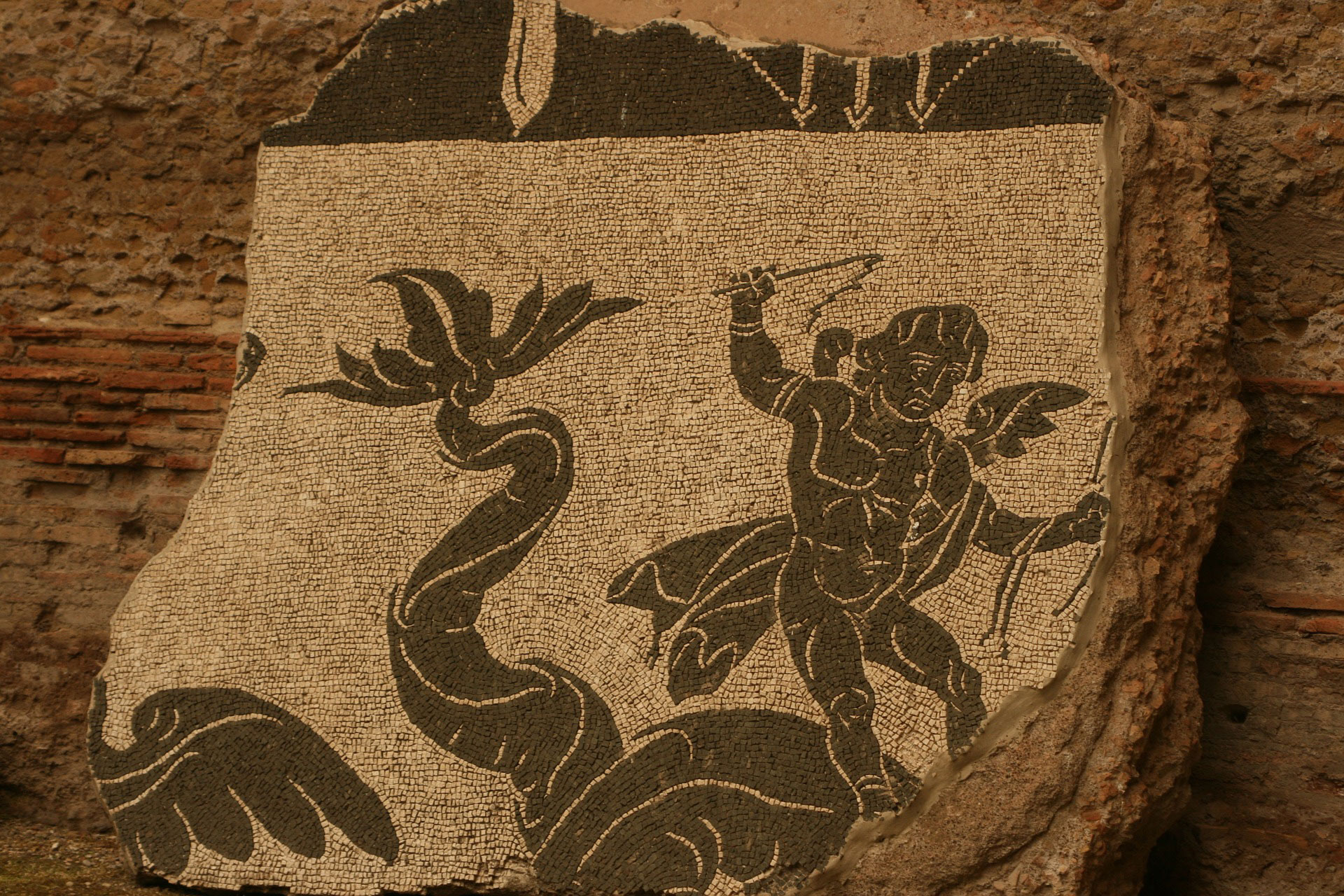 A stone block with mosaic artwork of ancient warrior riding a mythical beast