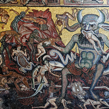 A medieval era painting depicting Hell with a large demon eating sinners perhaps as Dante might have envisioned Hell